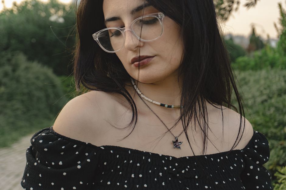 Portrait of a fashionable woman outdoors in Baku, Azerbaijan, wearing glasses and polka dot dress.
