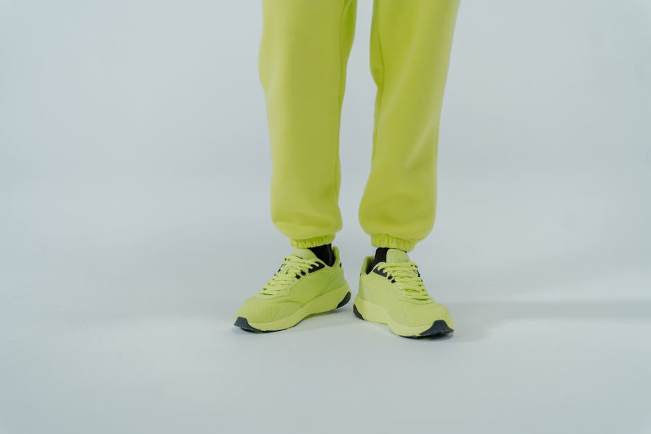 Lime green sneakers and pants on a clean white background, perfect for fashion advertising.