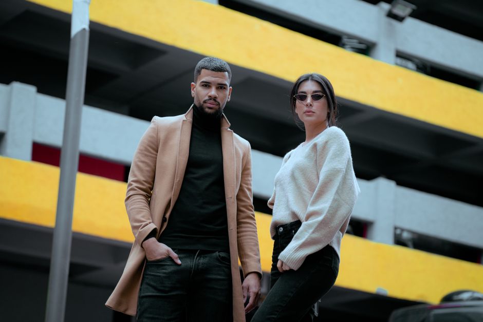 Fashionable couple poses confidently in an urban setting in Istanbul, Türkiye.