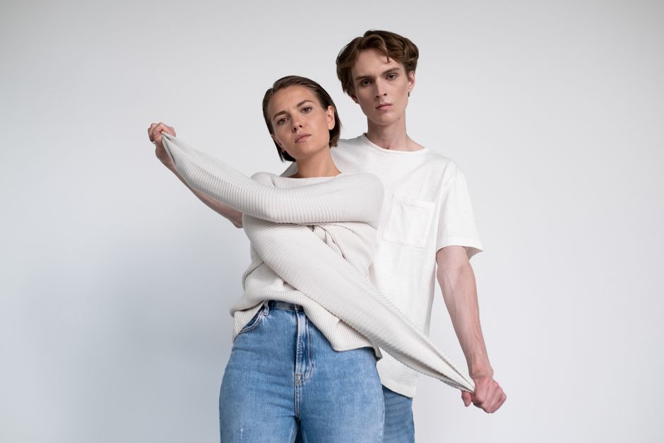Fashion models posing in stylish outfits during a studio photoshoot.