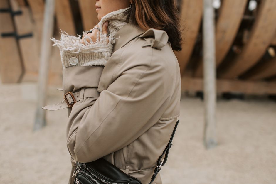 Close-up of a belted beige trench coat