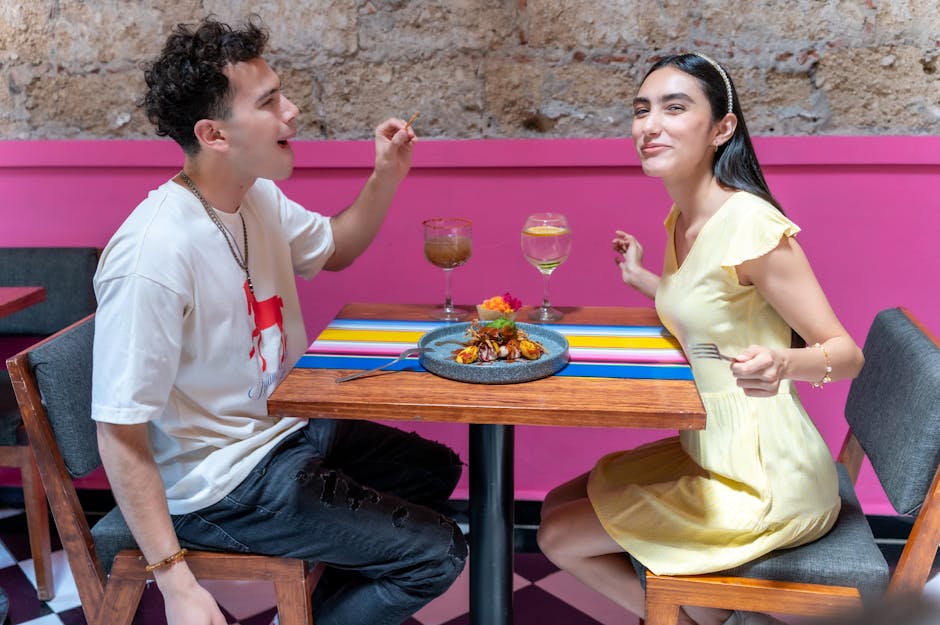 Young couple enjoying a meal in a colorful restaurant in CDMX, Mexico.