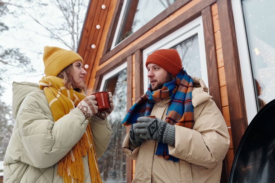 Friends in warm layered outfits on a winter evening