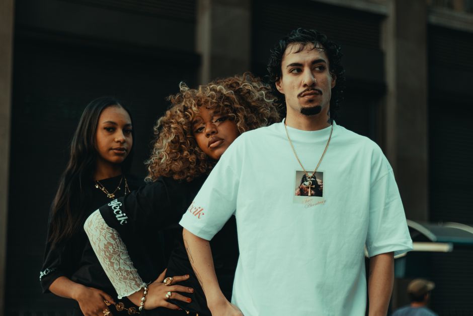 Stylish young adults in urban setting showcasing modern street fashion.