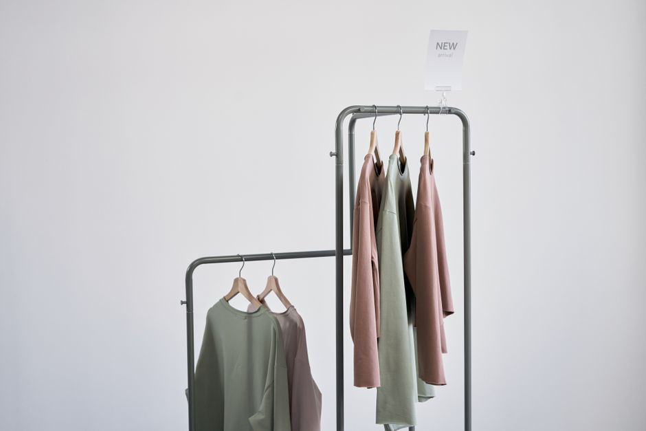 Elegant clothing rack showcasing new arrival blouses in a minimalist setting.