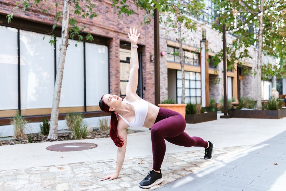 Young woman in athletic wear performing a yoga pose outdoors. Fitness and wellness concept.