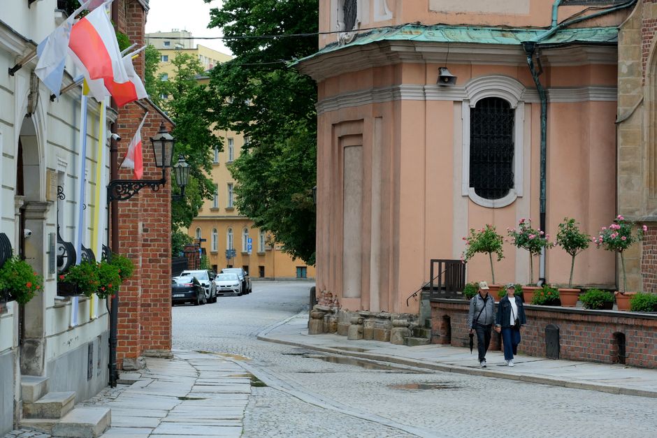 Quaint street with European historical architecture and national flags. Peaceful and scenic.