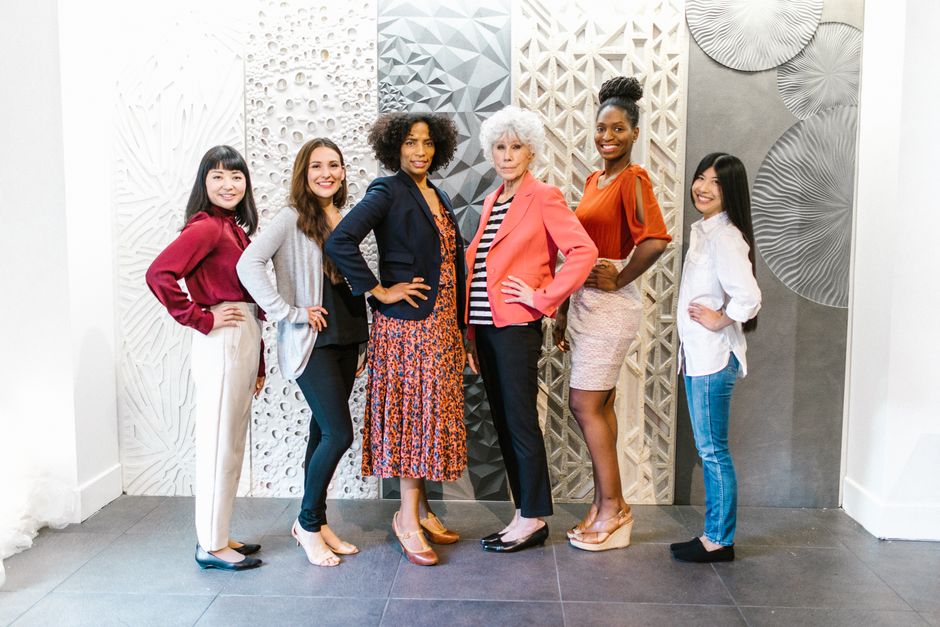 Group of confident women leaders posing in a stylish, modern office environment, showcasing empowerment and diversity.