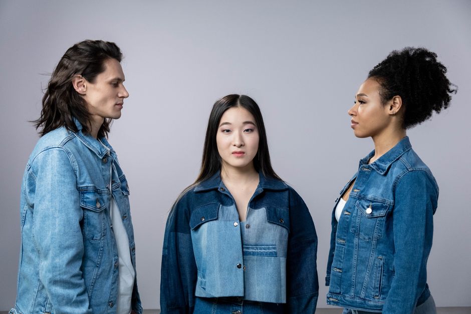 Three friends in stylish denim jackets, showcasing diversity and friendship.