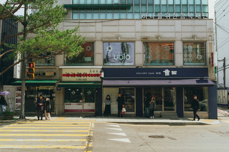 A lively street scene in downtown Seoul, showcasing Korean architecture and everyday city life.