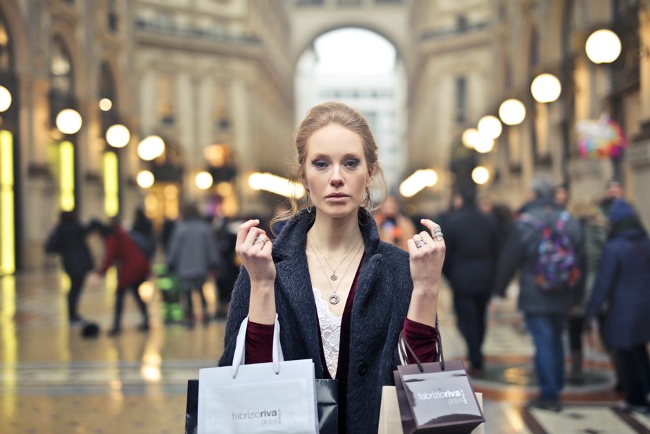 Elegant woman shopping with bags in Milan's iconic Galleria Vittorio Emanuele II.
