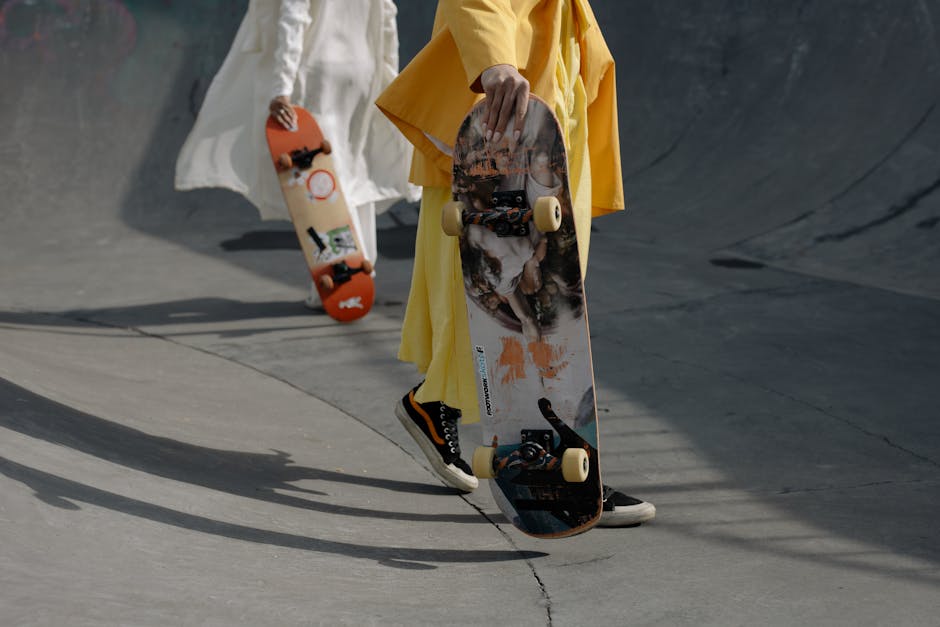 Two stylish individuals carrying skateboards at a skate park, showcasing urban fashion and outdoor activity.