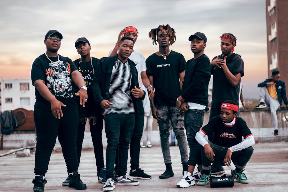 Stylish group of men posing confidently on a Durban rooftop during sunset. Fashionable urban vibe.