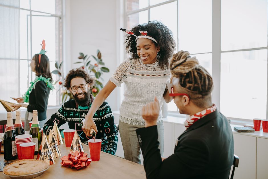 Joyful office holiday party with coworkers enjoying a festive celebration.
