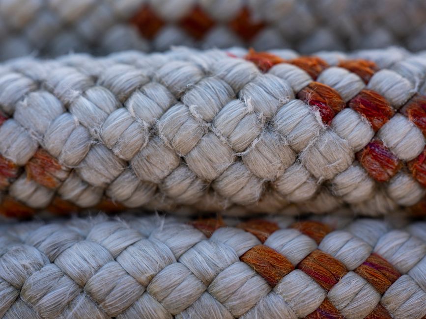 Detailed view of a tightly woven thick rope with a textured pattern, ideal for nautical themes.