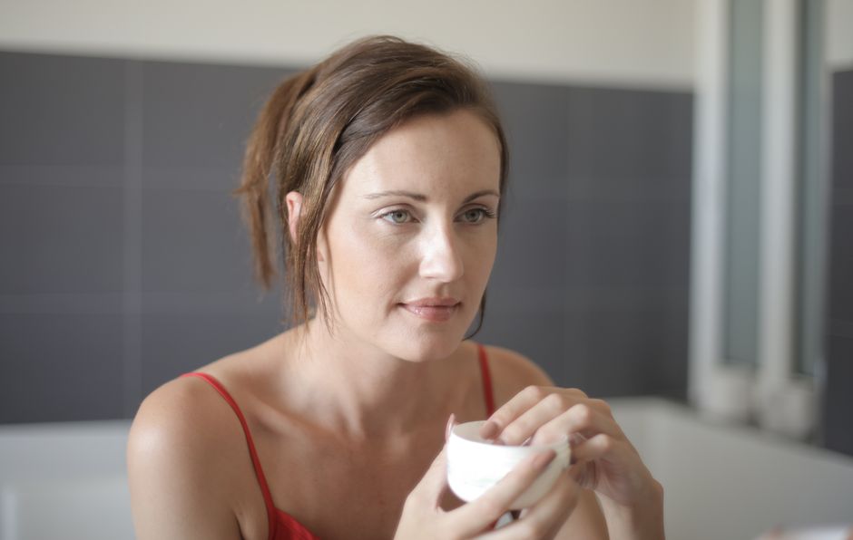 Woman applying gentle skincare to dull winter skin