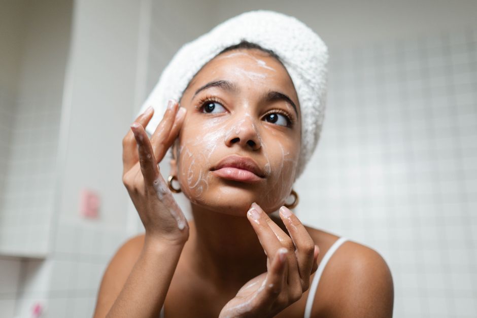 Woman applying moisturiser as part of a spring skincare routine